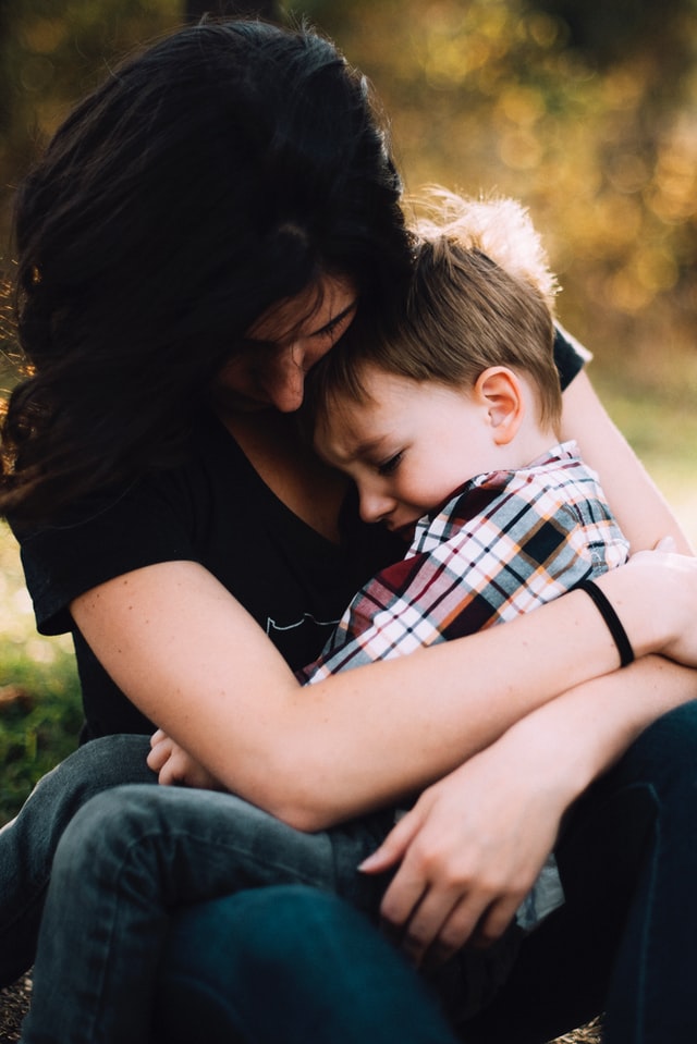 A mother and boy hugging