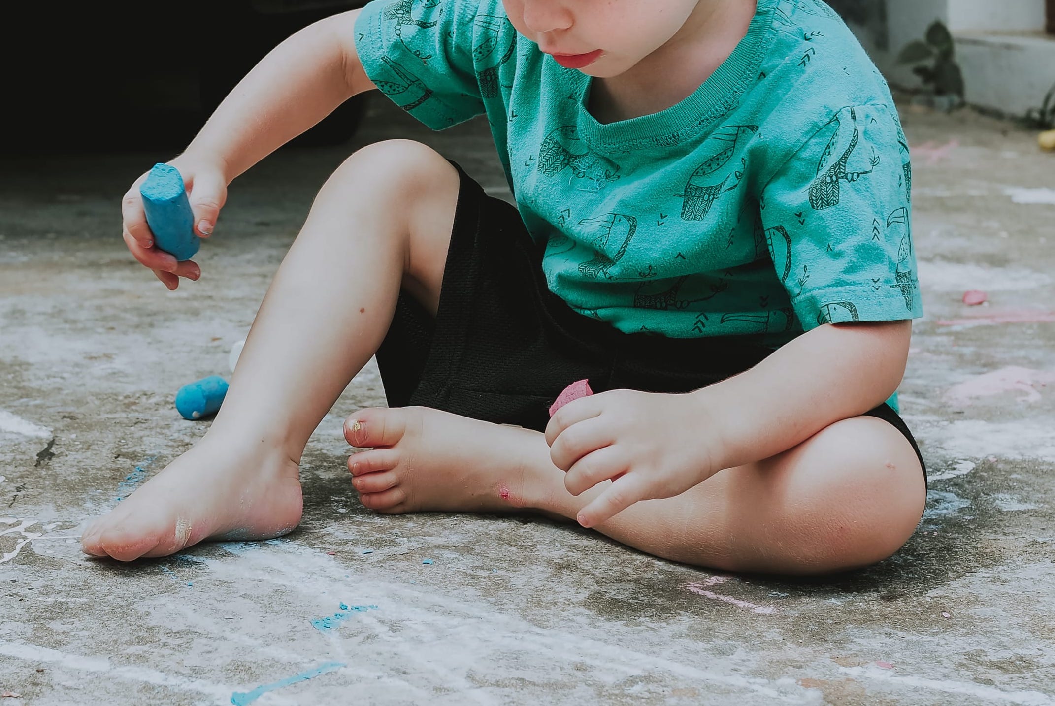 young boy sitting on floor