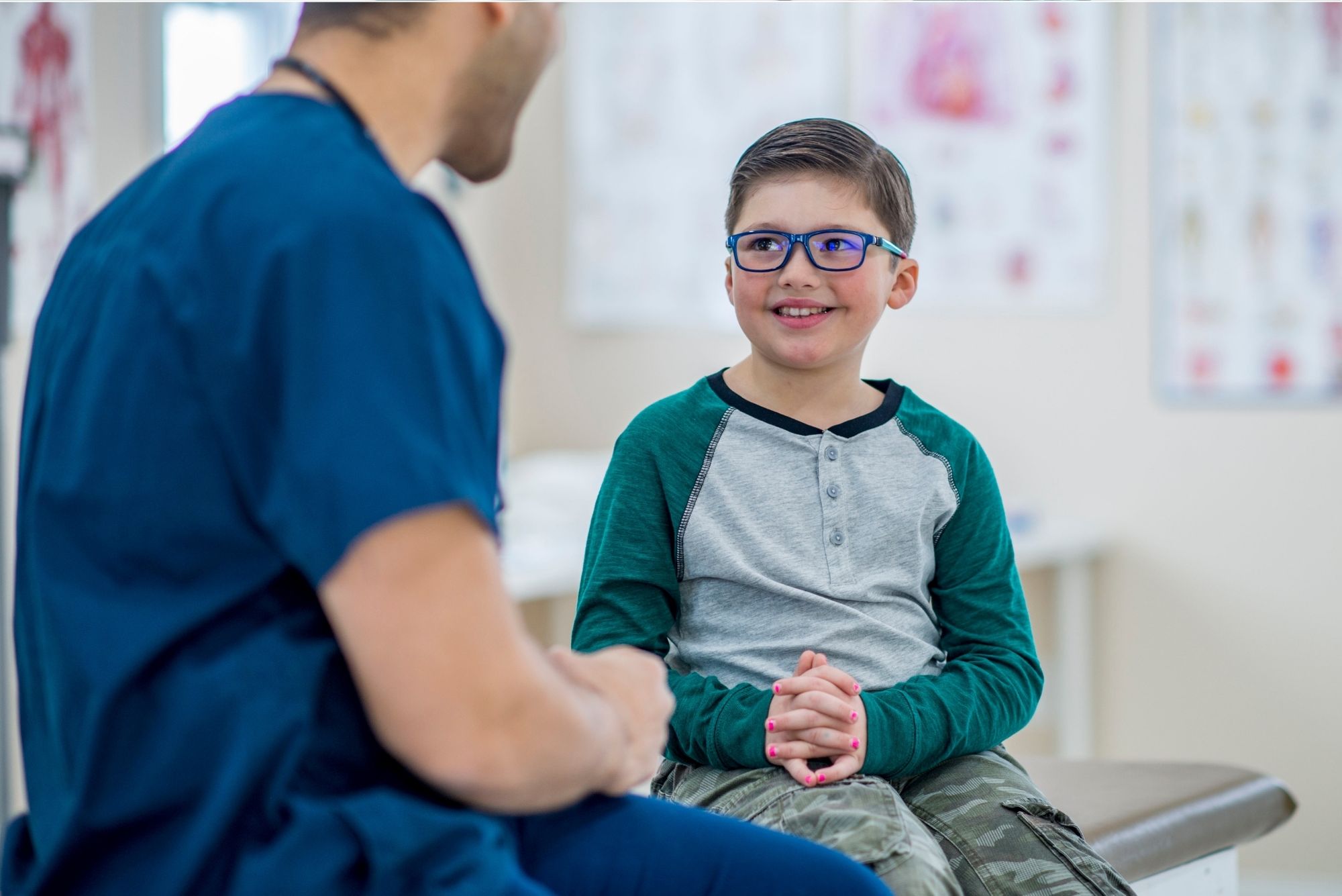 A young boy talking to a doctor
