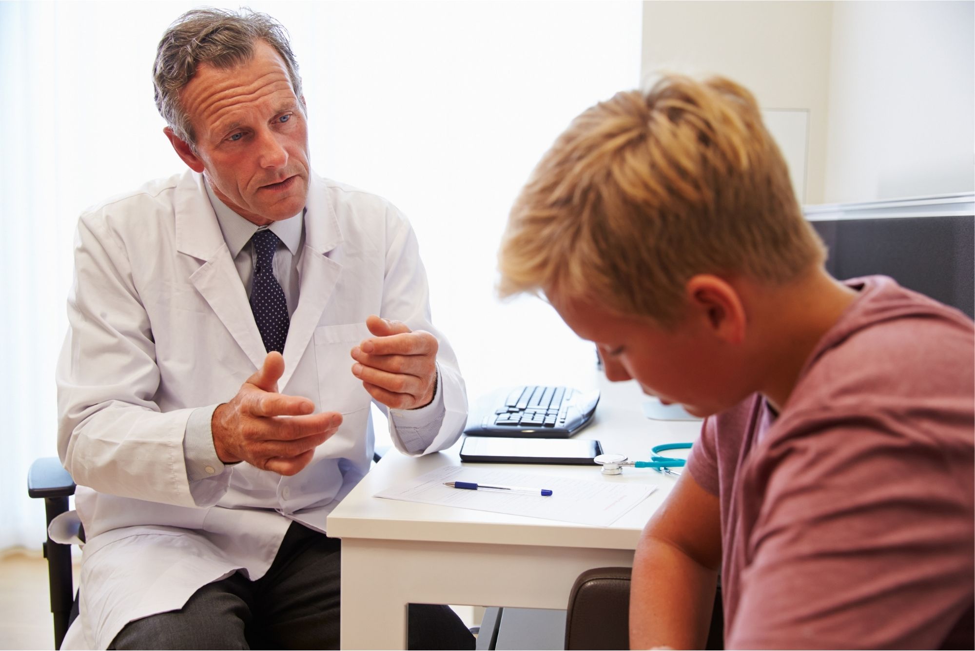 Teenage boy talking to doctor